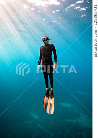 Diver Exploring Underwater Depths in Clear Blue Water During Daytime Diver Exploring Underwater Depths in Clear Blue Water During Daytime 129868431