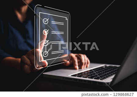 Woman using tablet, laptop futuristic digital interface icons manages checklist online quality control document management system streamlining workflow approval, advanced concept of modern efficiency Woman using tablet, laptop futuristic digital interface icons manages checklist online quality control document management system streamlining workflow approval, advanced concept of modern efficiency 129868627