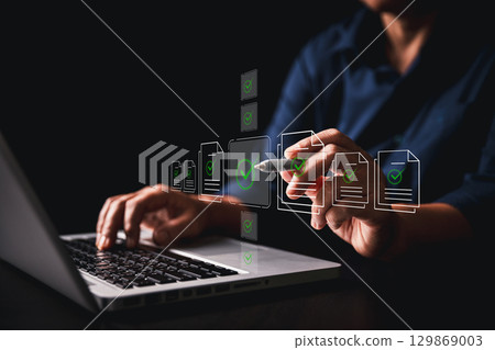 Businesswoman approving digital documents online checklist interface, embracing concept of paperless office task management, business processes, approvals are streamlined through an automated system 129869003