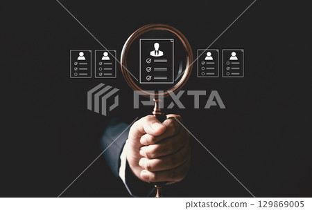 Concept of human resource recruitment visuals of magnifying glass highlighting ideal candidate icon, symbolizing process of headhunting, talent acquisition, employee selection, effective hiring. 129869005