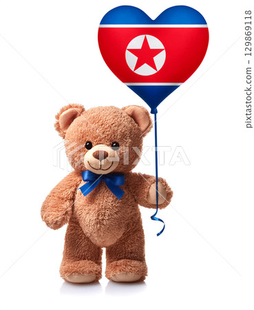 Cute teddy bear holding a heart-shaped balloon with the North Korean flag. White background. 129869118