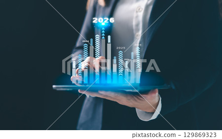 Business growth strategy for 2026. Businesswoman points ahead, symbolizing future success, company development, and business planning, driven by motivation and opportunity for the upcoming year. Business growth strategy for 2026. Businesswoman points ahead, symbolizing future success, company development, and business planning, driven by motivation and opportunity for the upcoming year. 129869323