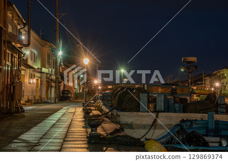 Fishing boats anchored in the port town at night [Shinminato Uchikawa] 129869374