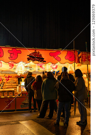 People lining up at a castella stall at a festival [Castella] 129869379