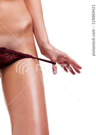 Woman is about to pull off her panties, isolated on white Woman is about to pull off her panties, isolated on white 129869421