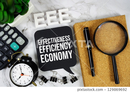 EEE Effectiveness, Efficiency and Economy acronym with calculator, alarm clock and magnifying glass, Business concept background 129869692