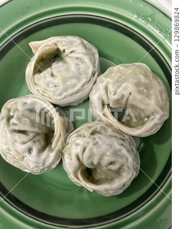 Korean dumplings filled with a mix of savory ingredients like ground meat, tofu, and vegetables. Mandu can be steamed, boiled, or pan-fried, making it a versatile and delicious snack or meal. Korean dumplings filled with a mix of savory ingredients like ground meat, tofu, and vegetables. Mandu can be steamed, boiled, or pan-fried, making it a versatile and delicious snack or meal. 129869824