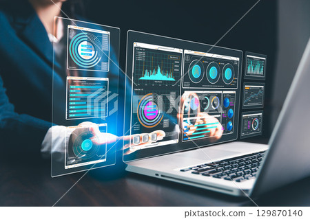 Woman in business uses computers and internet technology to perform SEO analysis, optimizing websites for search engine ranking and promoting increased traffic to boost website visibility. 129870140