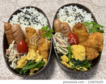 A traditional Korean dosirak, beautifully arranged with rice, assorted banchan, and savory proteins. Balanced and visually inviting, its a portable meal packed with vibrant flavors. A traditional Korean dosirak, beautifully arranged with rice, assorted banchan, and savory proteins. Balanced and visually inviting, its a portable meal packed with vibrant flavors. 129870205