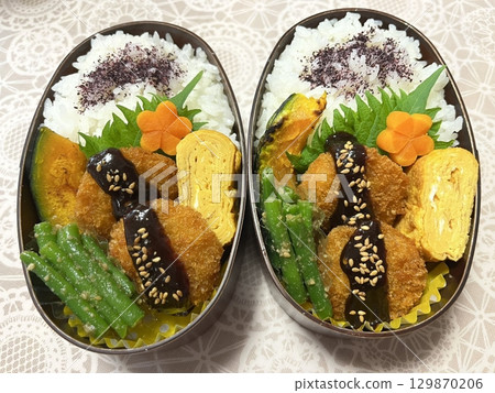 A traditional Korean dosirak, beautifully arranged with rice, assorted banchan, and savory proteins. Balanced and visually inviting, its a portable meal packed with vibrant flavors. A traditional Korean dosirak, beautifully arranged with rice, assorted banchan, and savory proteins. Balanced and visually inviting, its a portable meal packed with vibrant flavors. 129870206