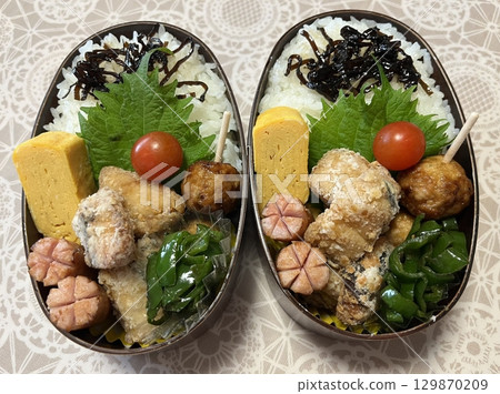 A traditional Korean dosirak, beautifully arranged with rice, assorted banchan, and savory proteins. Balanced and visually inviting, its a portable meal packed with vibrant flavors. 129870209