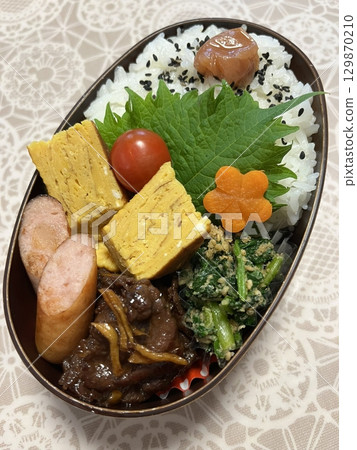 A traditional Korean dosirak, beautifully arranged with rice, assorted banchan, and savory proteins. Balanced and visually inviting, its a portable meal packed with vibrant flavors. 129870210