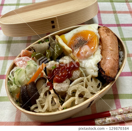 A traditional Korean dosirak, beautifully arranged with rice, assorted banchan, and savory proteins. Balanced and visually inviting, its a portable meal packed with vibrant flavors. A traditional Korean dosirak, beautifully arranged with rice, assorted banchan, and savory proteins. Balanced and visually inviting, its a portable meal packed with vibrant flavors. 129870384