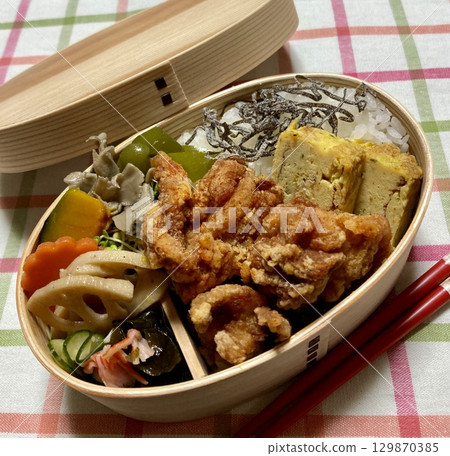 A traditional Korean dosirak, beautifully arranged with rice, assorted banchan, and savory proteins. Balanced and visually inviting, its a portable meal packed with vibrant flavors. A traditional Korean dosirak, beautifully arranged with rice, assorted banchan, and savory proteins. Balanced and visually inviting, its a portable meal packed with vibrant flavors. 129870385