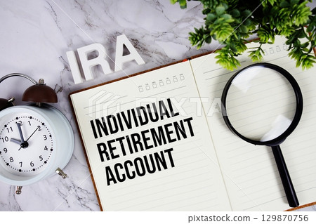 IRA Individual Retirement Account acronym on notepad, Business concept background 129870756