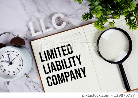 LLC Limited Liability Company acronym on notepad, Business concept background 129870757