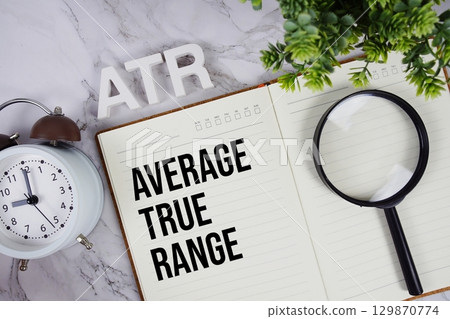 ATR Average True Range acronym on notepad, Business concept background 129870774