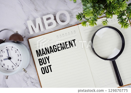 MBO Management Buyout acronym on notepad, Business concept background MBO Management Buyout acronym on notepad, Business concept background 129870775