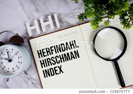 HHI Herfindahl Hirschman Index acronym on notepad, Marketing concept background 129870777