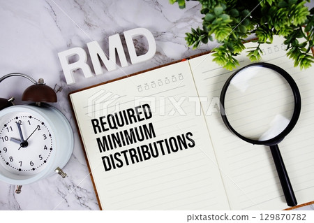 RMD Required Minimum Distributions acronym on notepad, Business concept background 129870782
