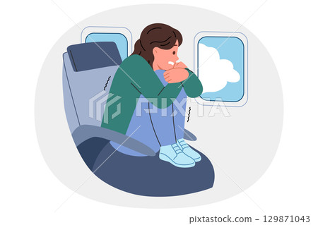 Aerophobia in woman flying in airplane, encountered turbulence, sitting in passenger seat airliner Aerophobia in woman flying in airplane, encountered turbulence, sitting in passenger seat airliner 129871043