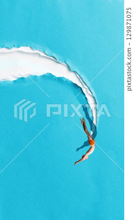 Minimalist pop art collage. Diver entering blue paper tear like breakthrough moment 129871075