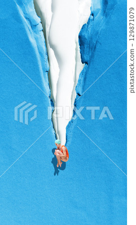 Bold colorful poster. Female diver tucked in pose jumping through torn paper into freedom 129871079