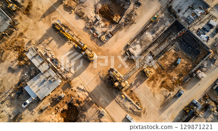 Construction site with crane, excavator, and scaffolding. design for building and development projects top view. 129871221