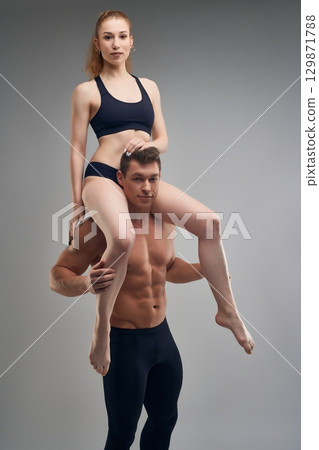 Sport support of woman and man during workout in studio 129871788
