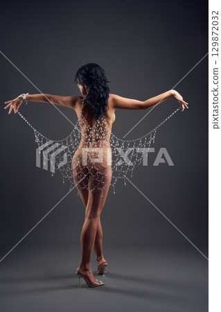 Naked graceful woman in beautiful glass cloak 129872032