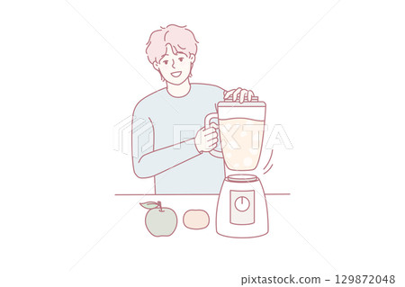 Smiling man making fruit juice in blender 129872048