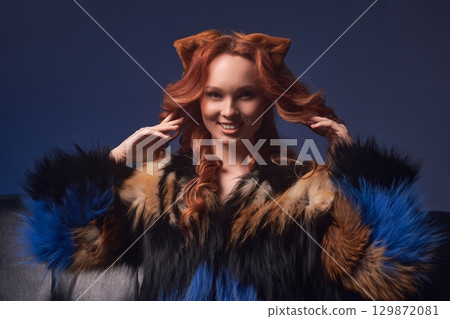 Alluring redhead woman fox showing touching her hair Alluring redhead woman fox showing touching her hair 129872081