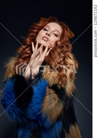 Alluring redhead woman fox showing touching her face Alluring redhead woman fox showing touching her face 129872102