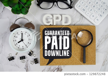 GPD Guaranteed Paid Downline text with Calculator, alarm clock and magnifying glass on marble background GPD Guaranteed Paid Downline text with Calculator, alarm clock and magnifying glass on marble background 129872248