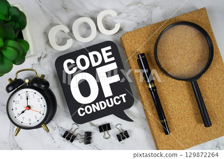 COC Code of Conduct text with alarm clock and magnifying glass on marble background COC Code of Conduct text with alarm clock and magnifying glass on marble background 129872264