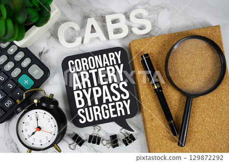 CABS Coronary Artery Bypass Surgery text with Calculator, alarm clock and magnifying glass on marble background 129872292