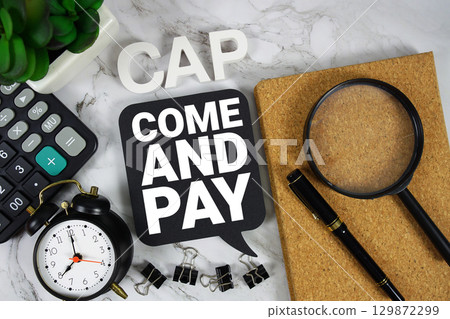 CAP Come And Pay text with Calculator, alarm clock and magnifying glass on marble background CAP Come And Pay text with Calculator, alarm clock and magnifying glass on marble background 129872299
