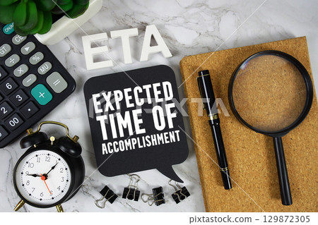 ETA Expected Time of Accomplishment text with Calculator, alarm clock and magnifying glass on marble background ETA Expected Time of Accomplishment text with Calculator, alarm clock and magnifying glass on marble background 129872305