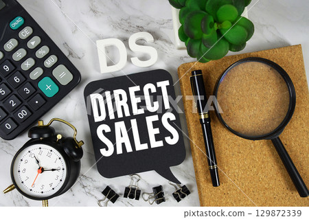 DS Direct Sales text with Calculator, alarm clock and magnifying glass on marble background 129872339