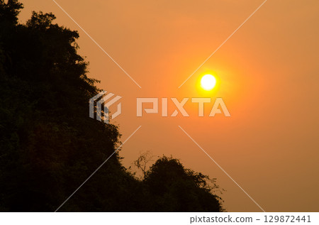 Sunset over a limestone cliff. 129872441