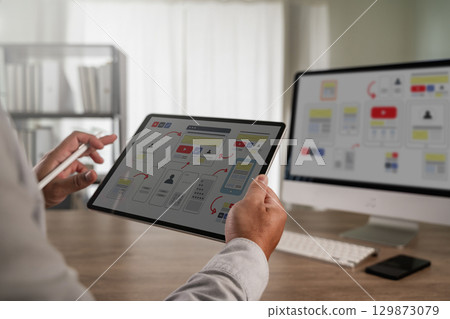 UX UI design process concept showing a designer UX UI design process concept showing a designer 129873079