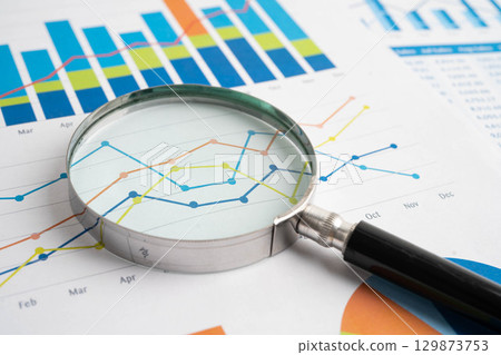 Magnifying glass on charts graphs paper. Financial development, Banking Account, Statistic, Investment Analytic research data economy. 129873753