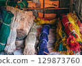 multicolored dry dyed reeds lie in piles at warehouse for the production of traditional woven mats in a Vietnamese village in Vietnam 129873760
