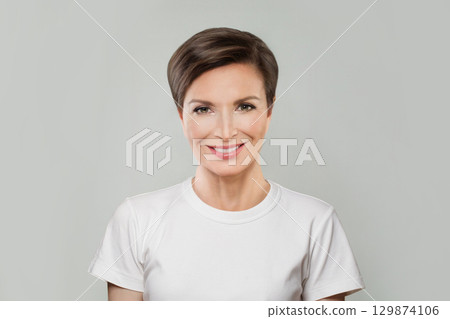 Successful mid aged mature woman looking at camera and smiling. Healthy face skin care beauty Successful mid aged mature woman looking at camera and smiling. Healthy face skin care beauty 129874106