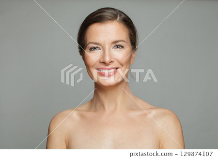 Glorious mid aged mature woman looking at camera and smiling. Healthy face skin care beauty 129874107