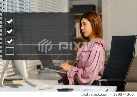 woman using tablet to do online checklist survey, doing assessment online survey answer test questions Digital form 129874366
