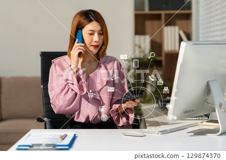 women talk mobile phones update tasks with milestones progress planning while working on laptop computers, online business, work from home, teleworking concept. women talk mobile phones update tasks with milestones progress planning while working on laptop computers, online business, work from home, teleworking concept. 129874370