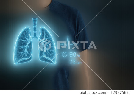 Medical hologram of human lung with heartbeat rate display glowing in blue light showing health monitoring concept 129875633