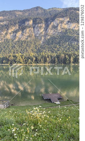 Serene Lake Reflection with Mountain Backdrop 129876032