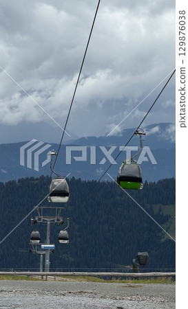 Scenic Mountain Cable Cars Gliding Above Forested Hills Scenic Mountain Cable Cars Gliding Above Forested Hills 129876038